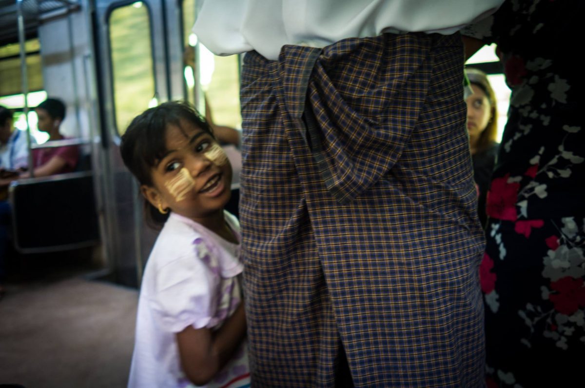The smiling girl with square thanaka marking .Taken at the loop train of Yangon.